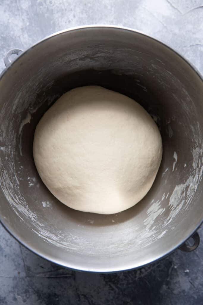 homemade pizza dough in a mixing bowl