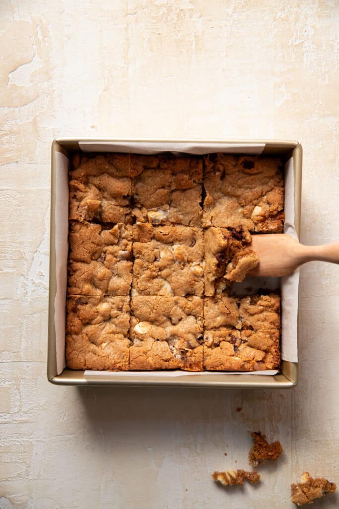 s'mores cookie bars in a square baking pan cut up