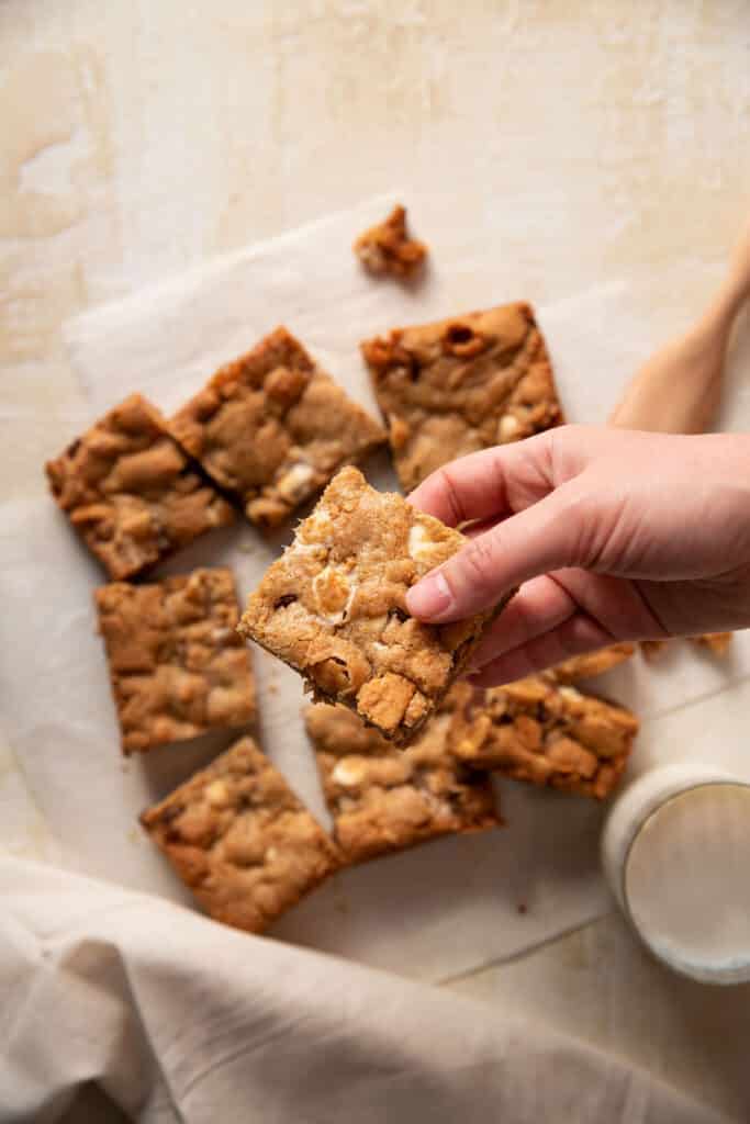 s'mores cookie bars on a piece of parchment paper cut into squares