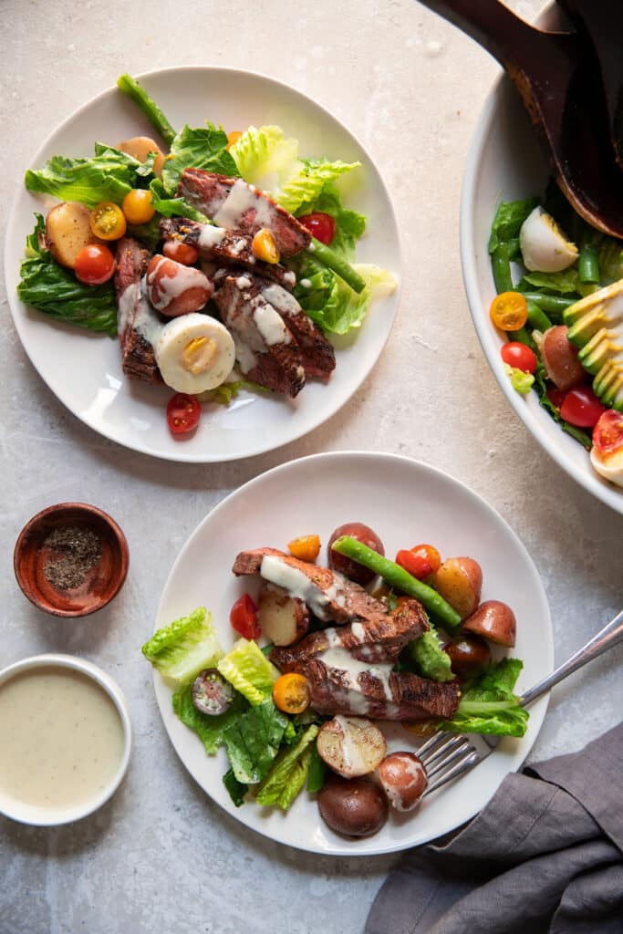 steak and vegetables in a bowl and on plates for dinner