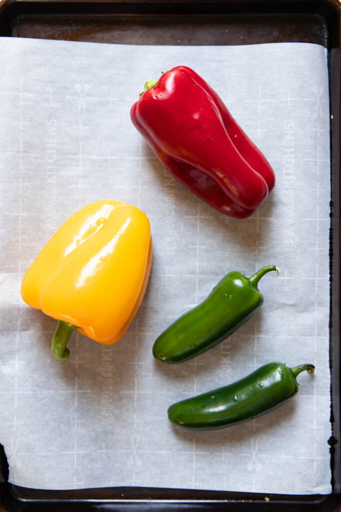 Bell peppers on a baking sheet.