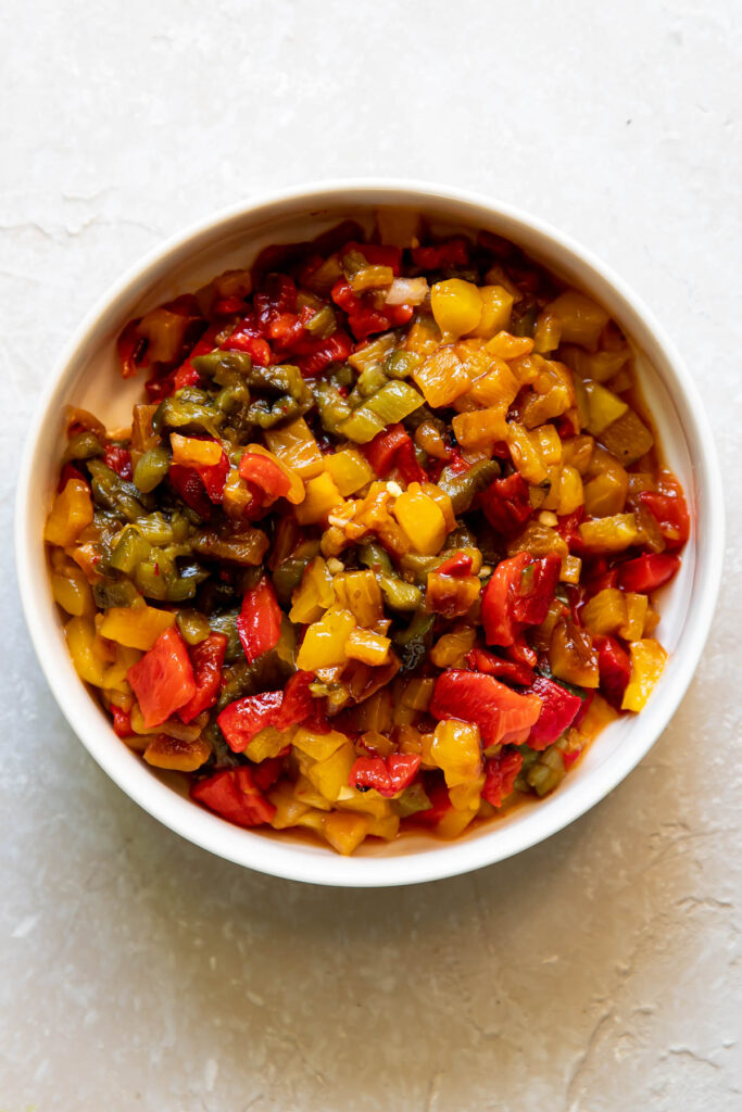 Bowl of chopped up roasted bell peppers.