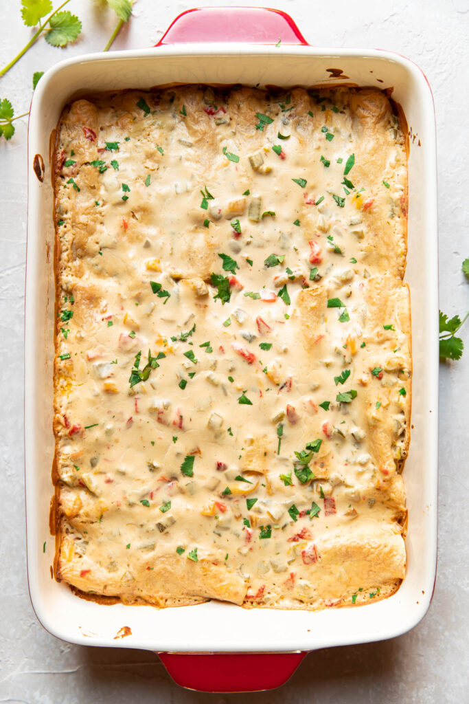 Enchiladas in a baking dish after being baked.