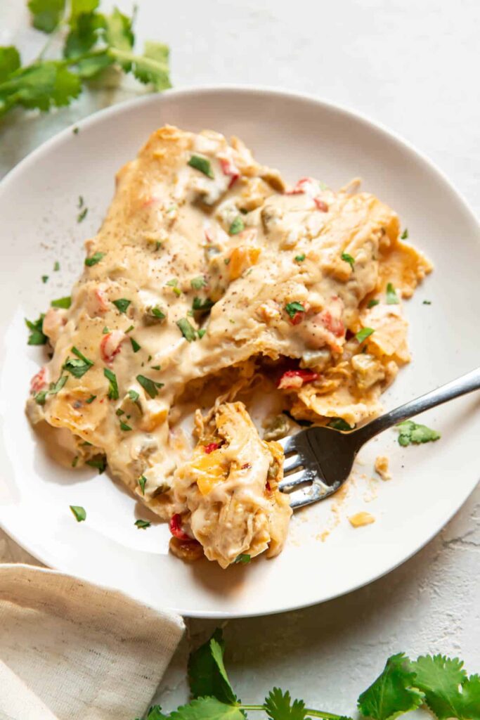 Enchiladas on a plate with a fork.