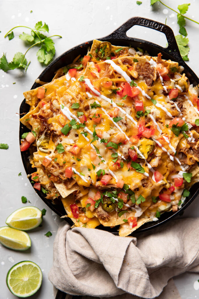 carnitas nachos in a skillet.