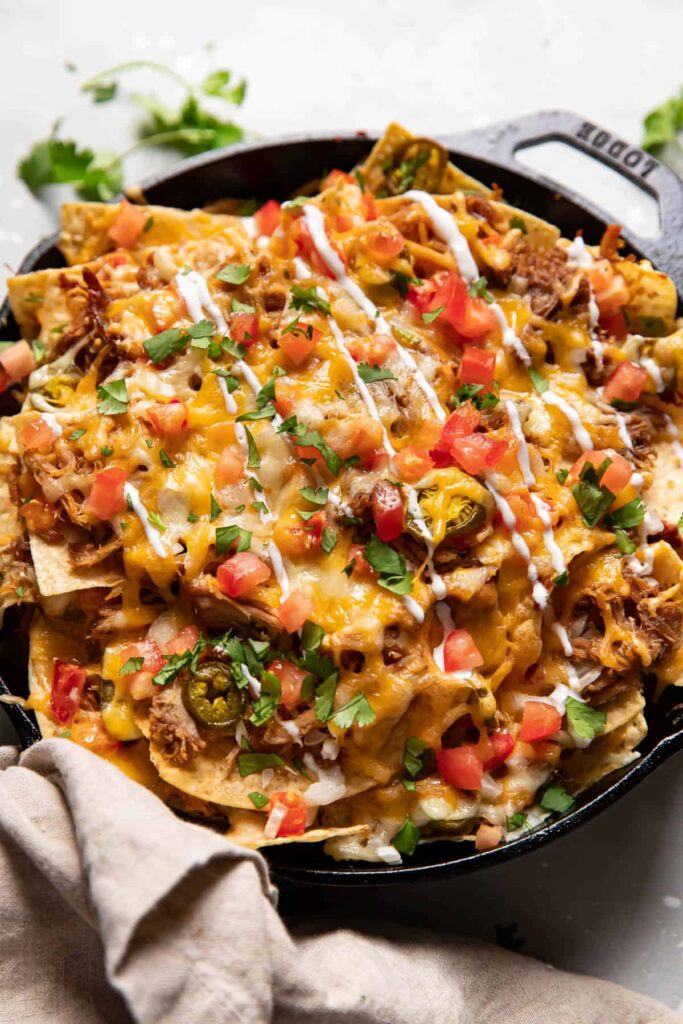 carnitas nachos in a skillet.