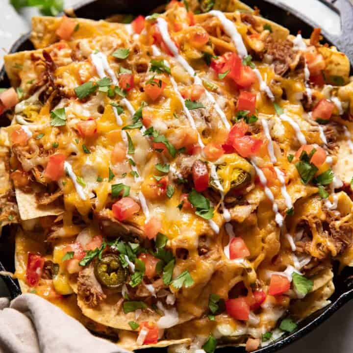 carnitas nachos in a skillet.