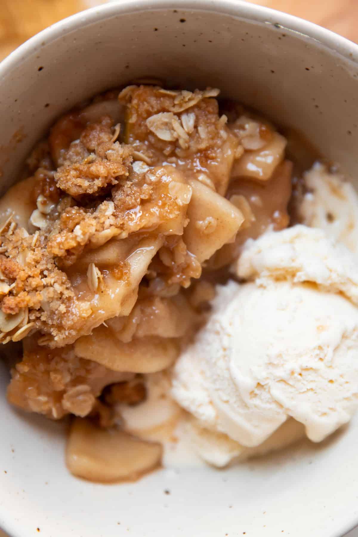 apple crisp in a bowl with ice cream