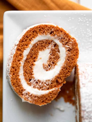 slice of pumpkin roll with cream cheese frosting.
