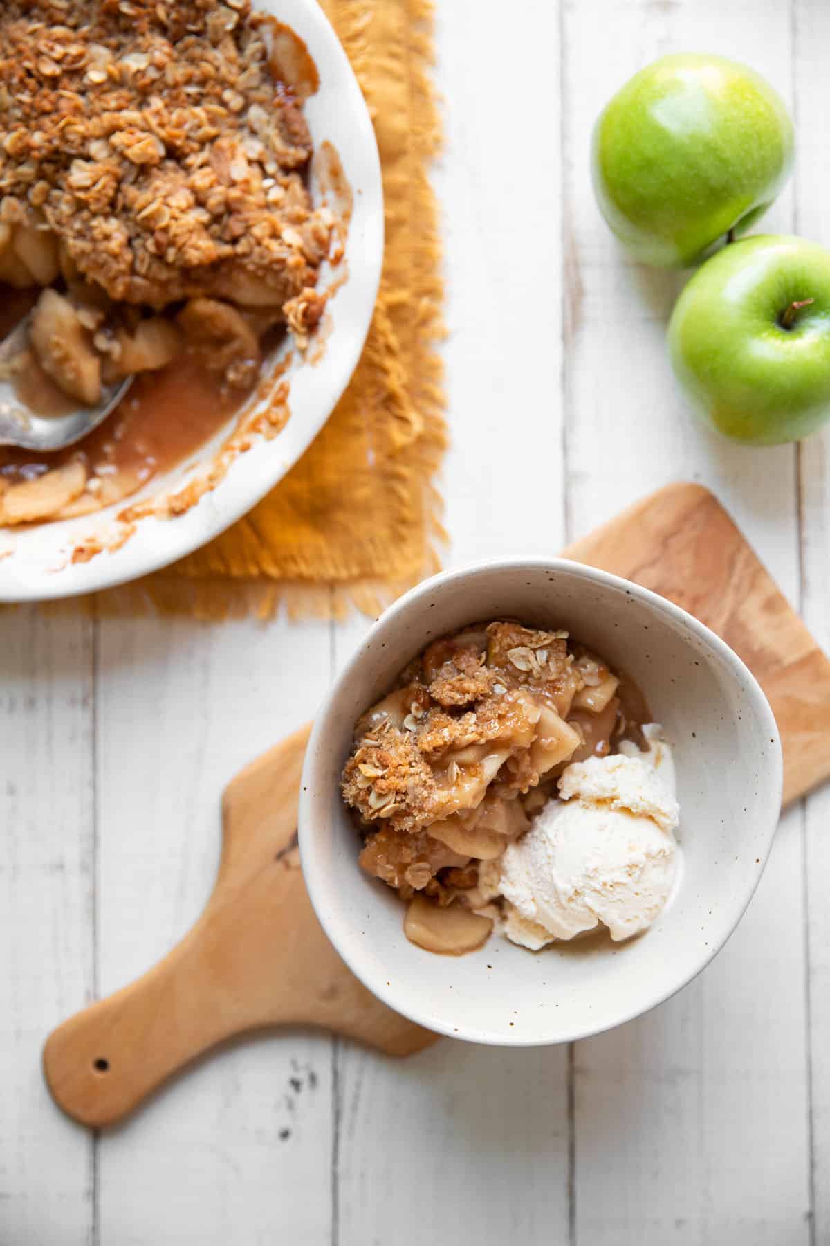 bowl of apple crisp and vanilla ice cream