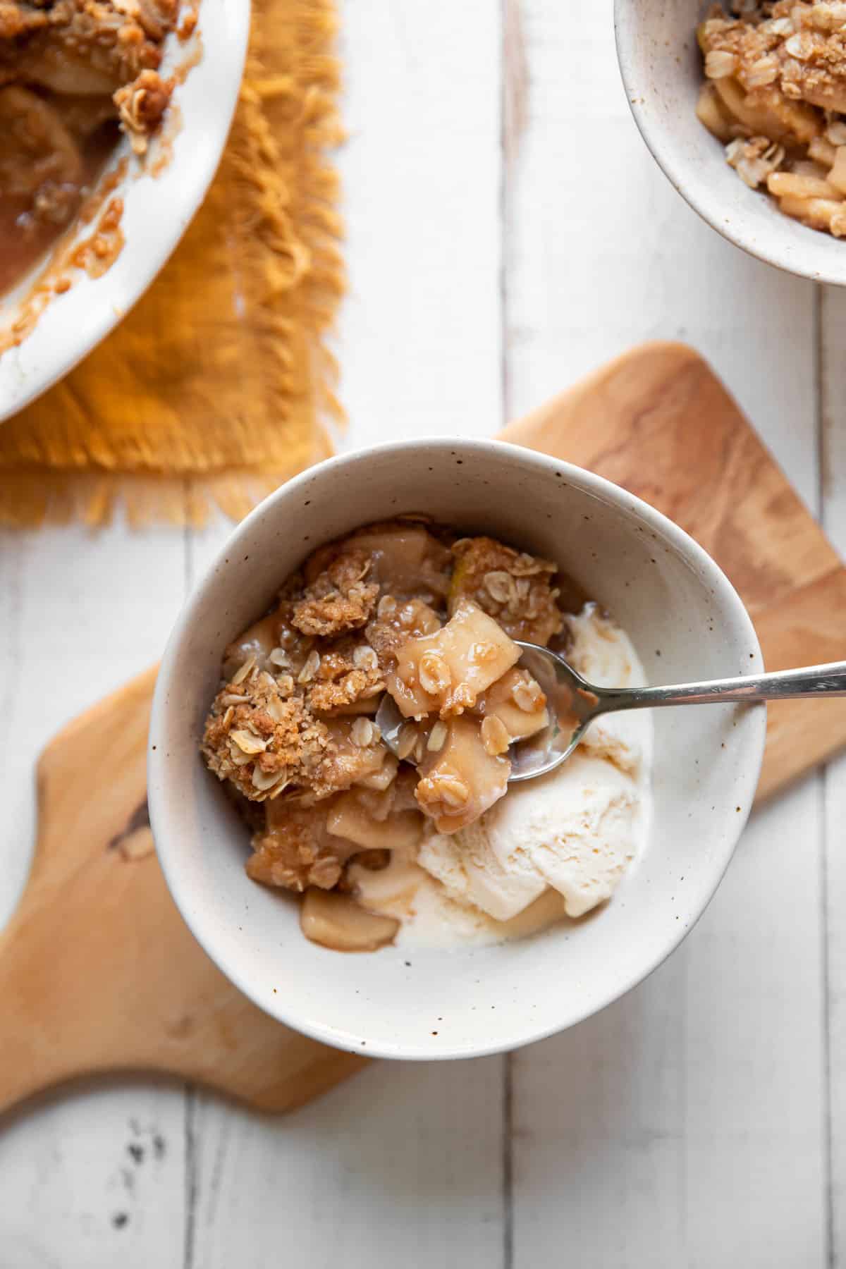 bowl of apple crisp and vanilla ice cream