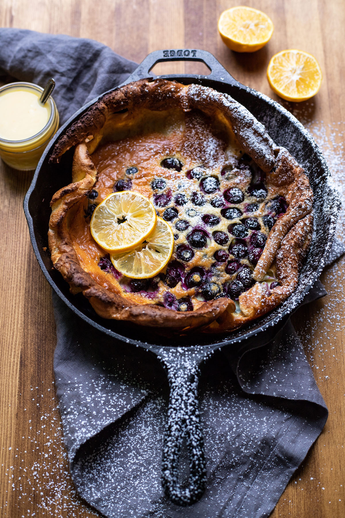 puffy blueberry dutch baby pancake with lemon curd