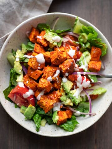 buffalo chicken salad with carrots tomatoes and celery in a bowl