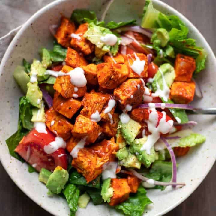 buffalo chicken salad with carrots tomatoes and celery in a bowl