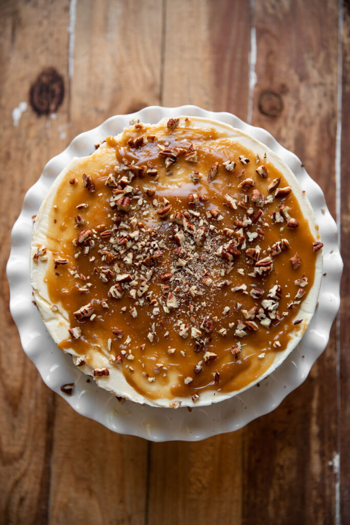 Cheesecake layered between chocolate cake and salted caramel with pecans