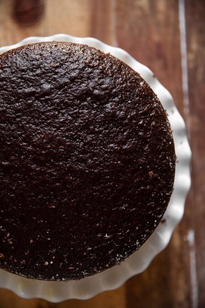 Cheesecake layered between chocolate cake and salted caramel with pecans