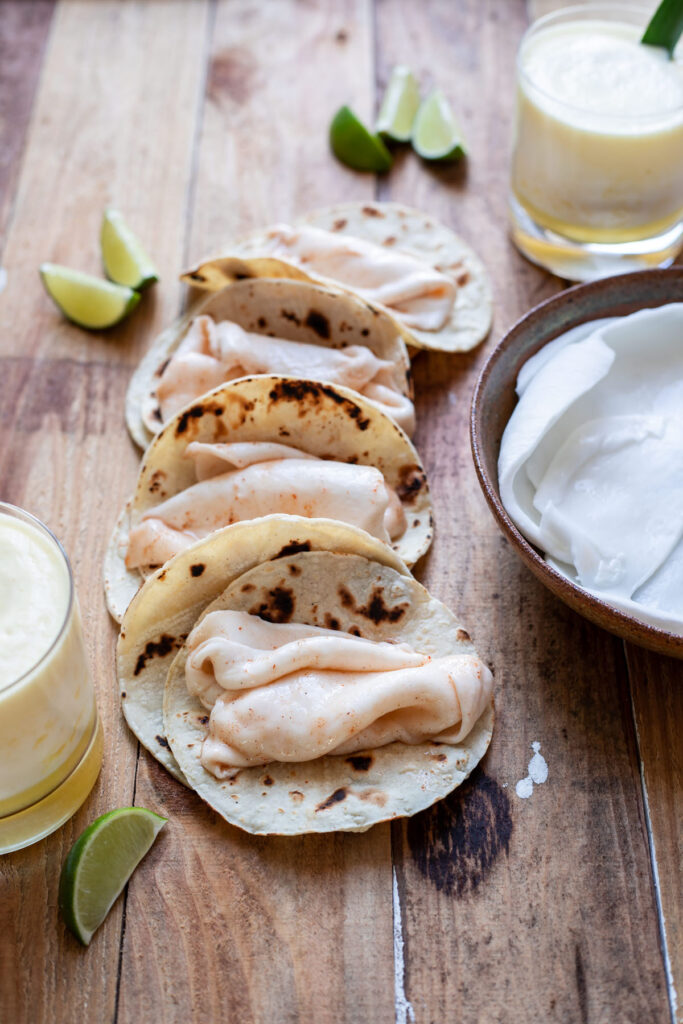 coconut meat dipped in chili lime sauce in a taco