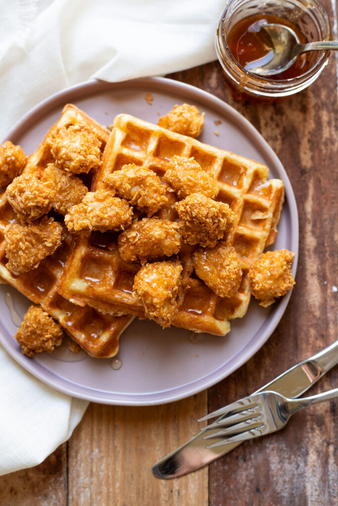 crispy baked chicken nuggets and buttermilk waffles with sriracha honey