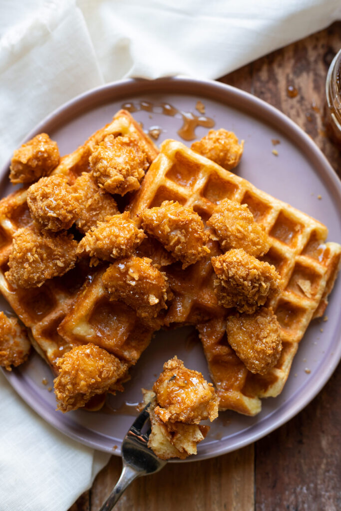 crispy baked chicken nuggets and buttermilk waffles with sriracha honey