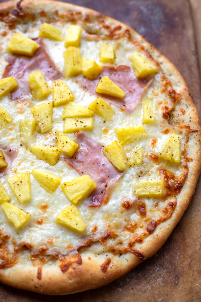 pizza with olive oil mozzarella cheese ham and pineapple