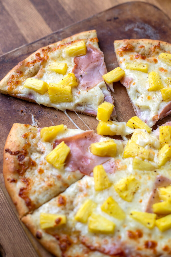 pizza with olive oil mozzarella cheese ham and pineapple