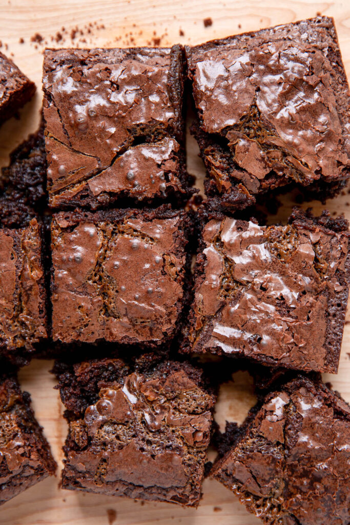 Brownies on a cutting board in squares.