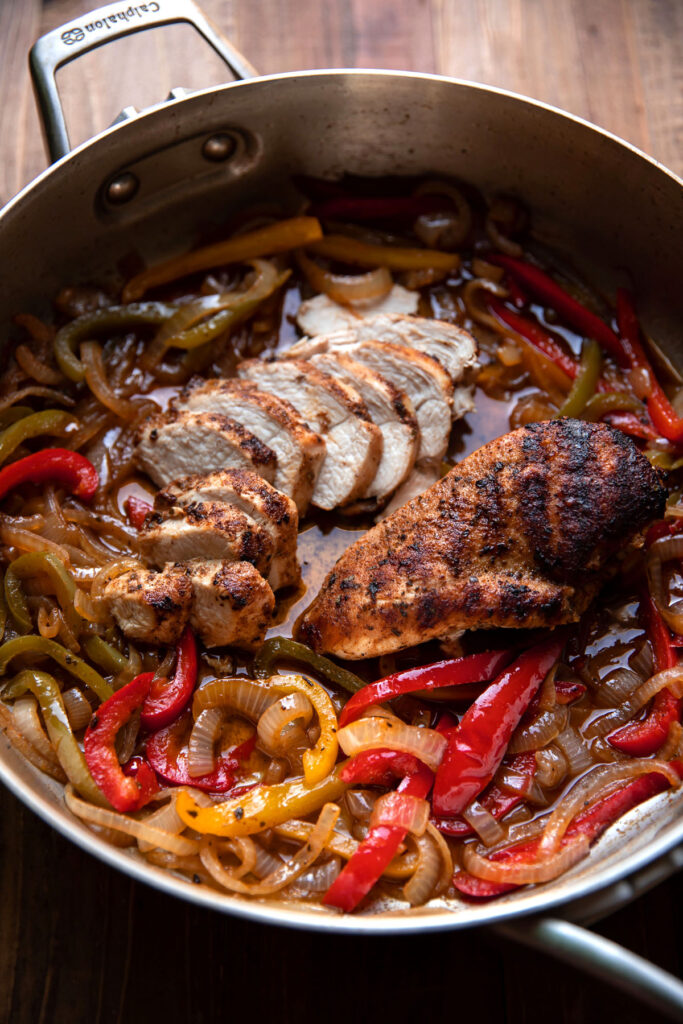 mesquite chicken breast and bell peppers in a pan