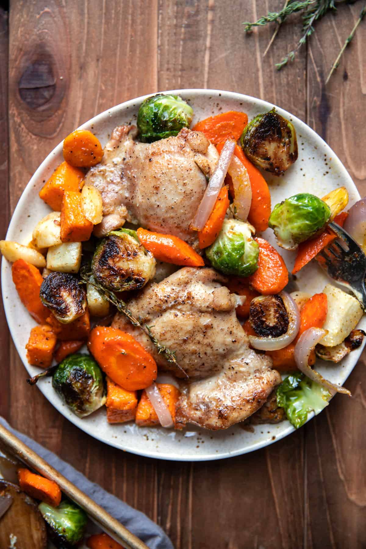 sheet pan with roasted chicken thighs and root vegetables