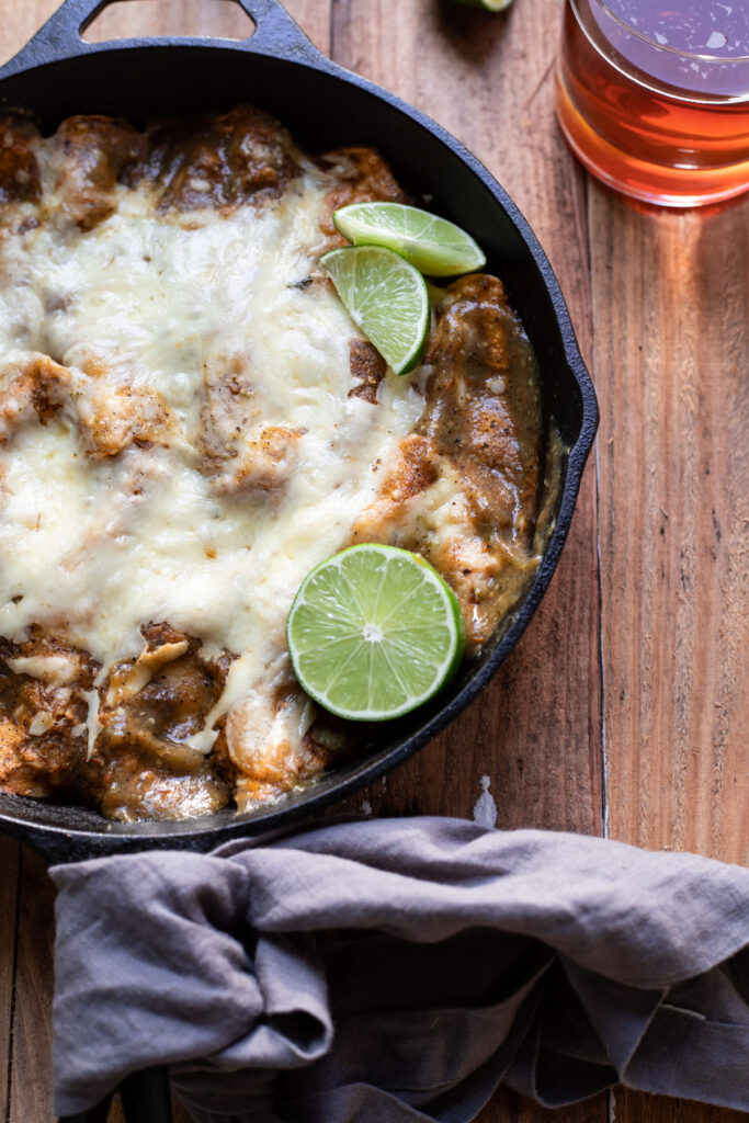 corn tortilla short rib enchiladas in a skillet