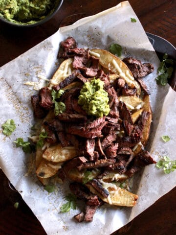 Steak piled high on cheesy french fries topped with guacamole.