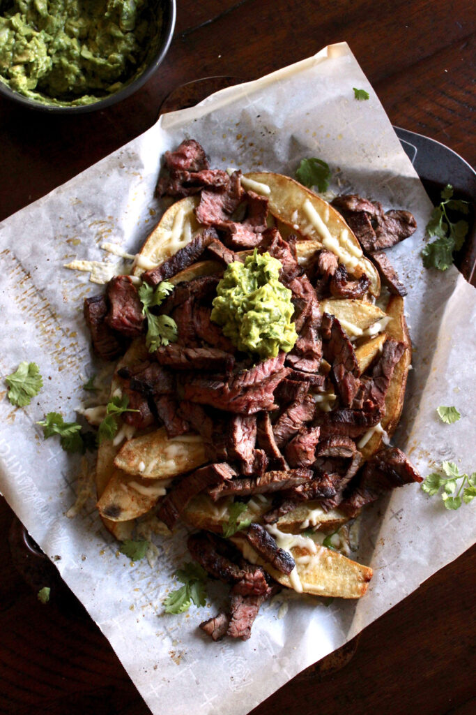 Steak piled high on cheesy french fries topped with guacamole.