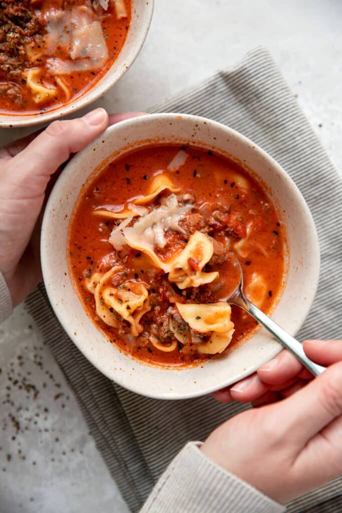tomato soup with cheese tortellinis and ground beef in a bowl