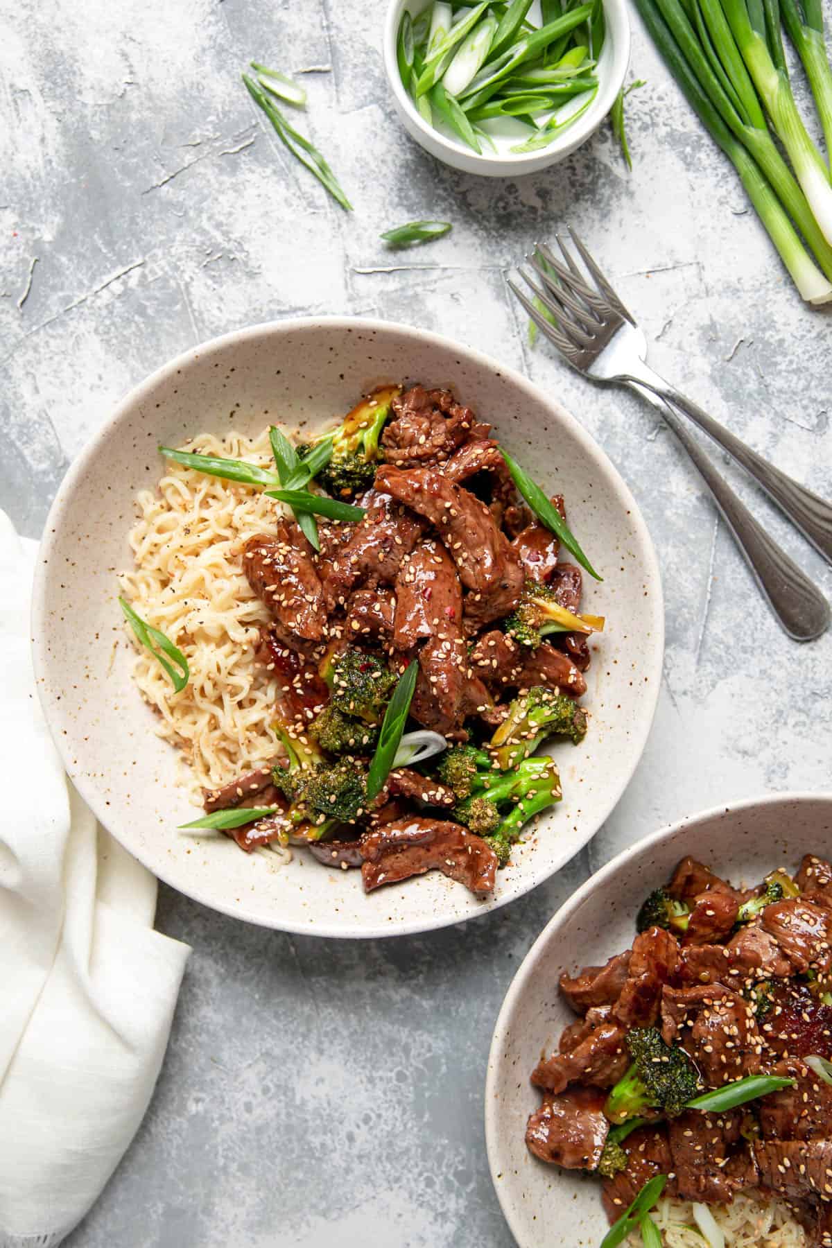 beef and broccoli with ramen noodles in a bowl.