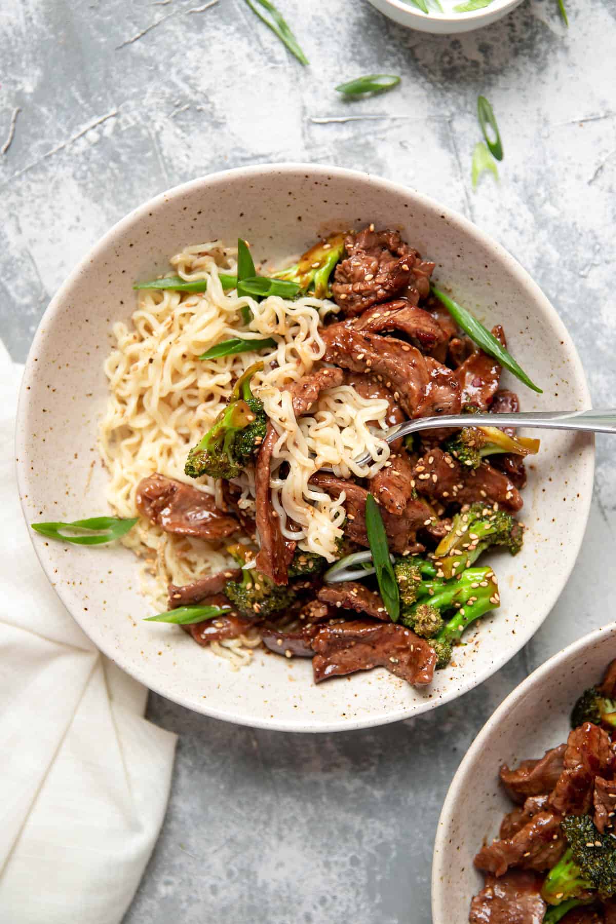 beef and broccoli with ramen noodles in a bowl.