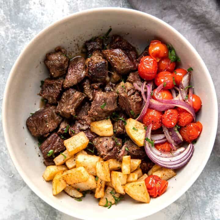 slow cooker steak bites with butter lemon sauce tomato and crispy potatoes