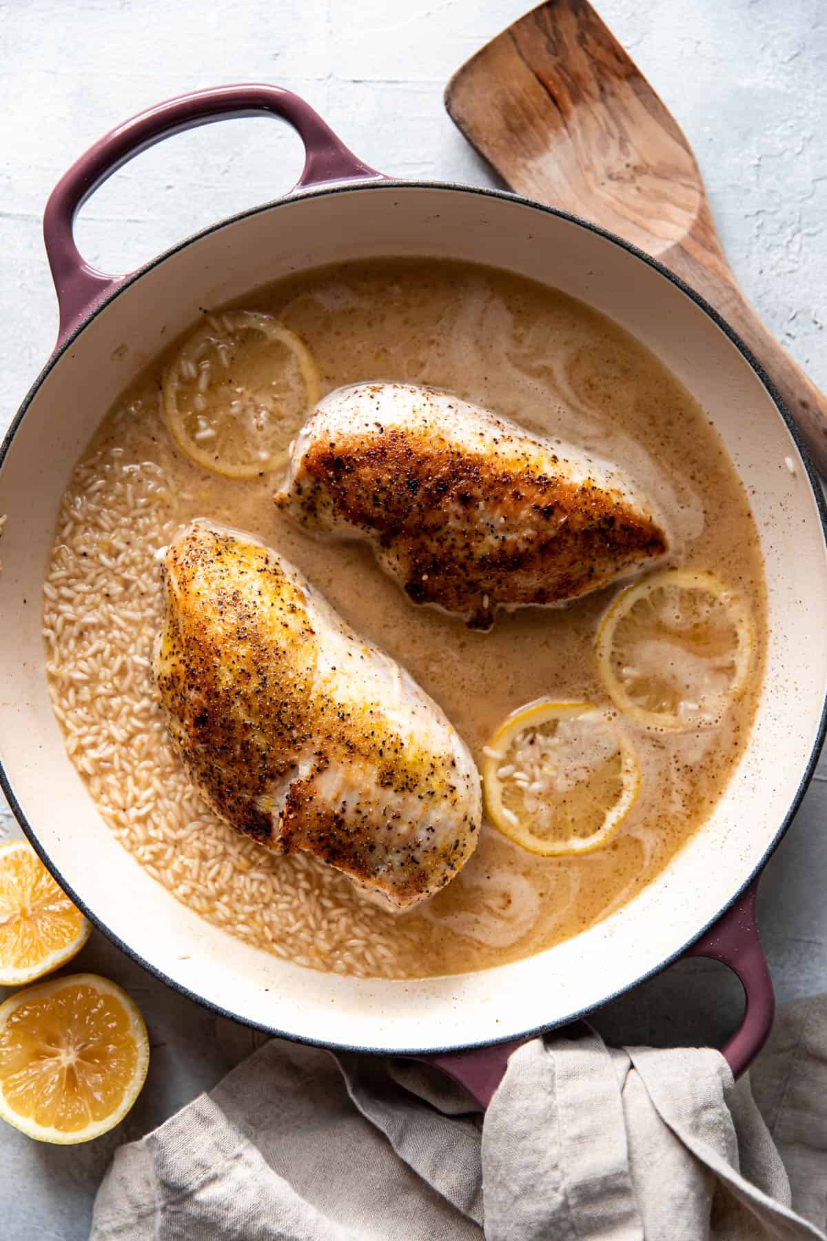 lemon chicken and rice in a pan before being cooked.