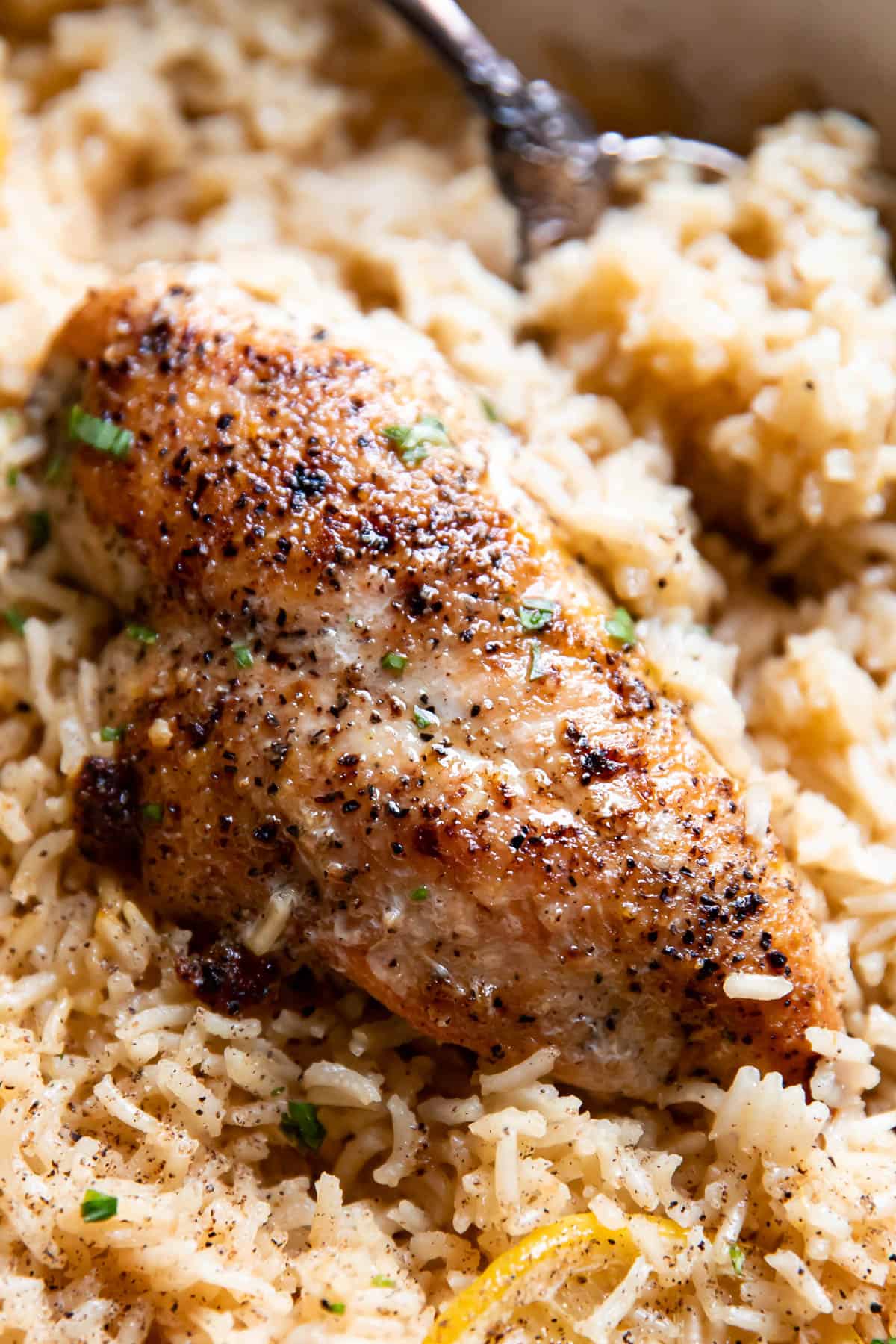 lemon chicken and rice in a pan.