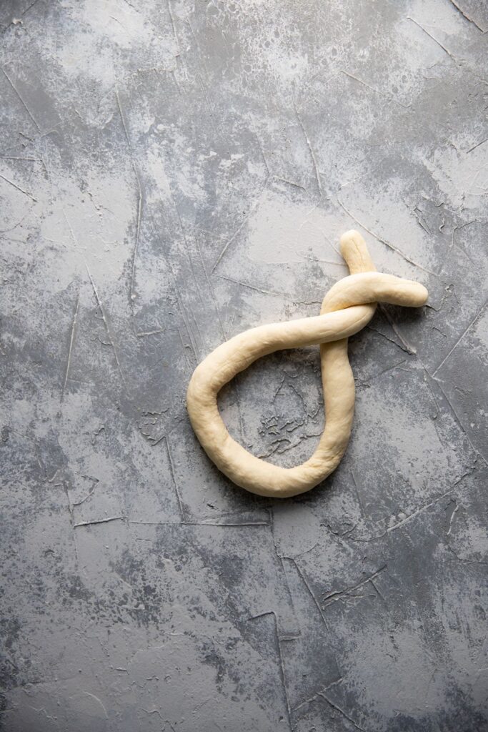 twist dough into a soft pretzel on a flat surface
