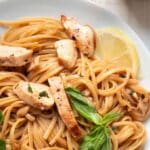 chicken and linguine pasta with a lemon sauce in a stainless steel pan