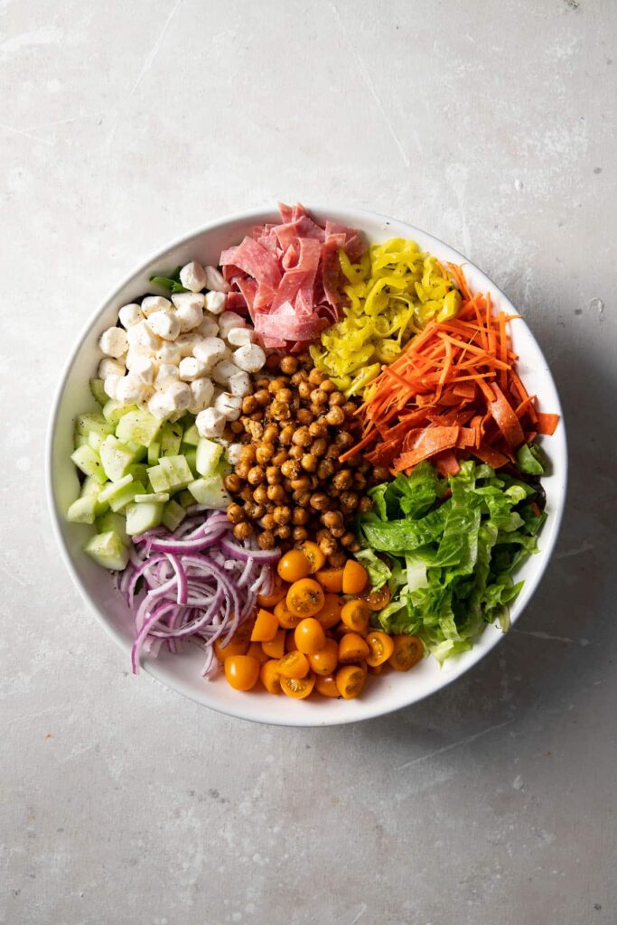 italian chopped salad with roasted chickpeas in a white bowl