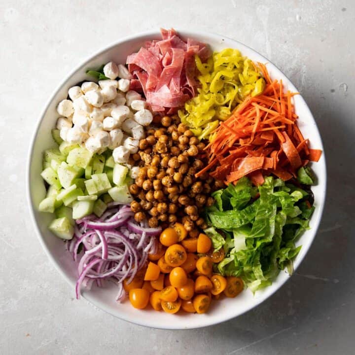 italian chopped salad with roasted chickpeas in a white bowl