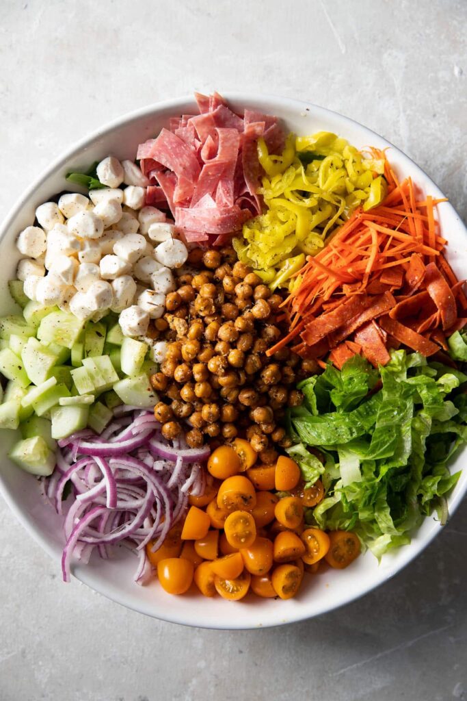 italian chopped salad with roasted chickpeas in a white bowl