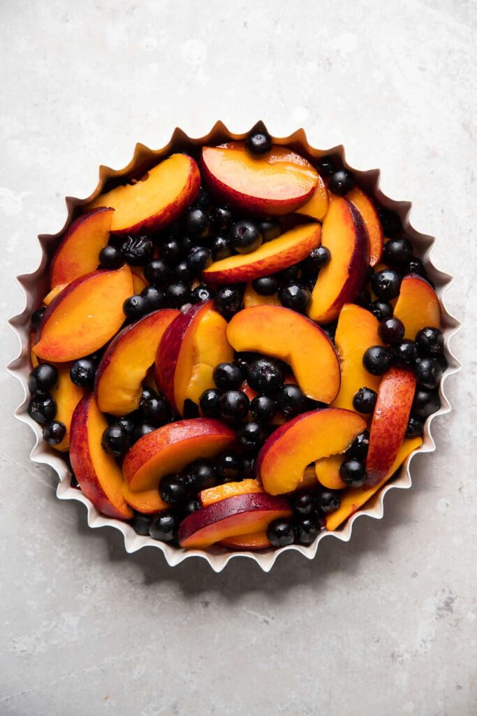 baking dish with blueberries and peaches