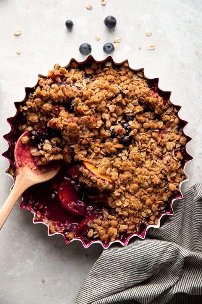 baking dish with blueberry peach crisp after baking