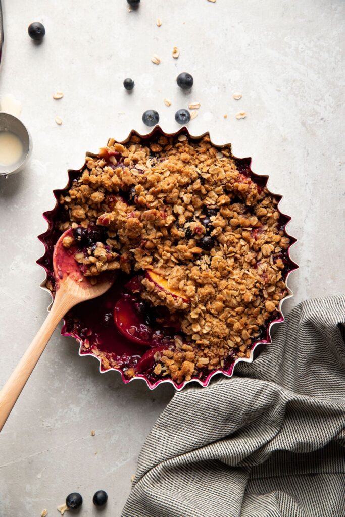 baking dish with blueberry peach crisp after baking