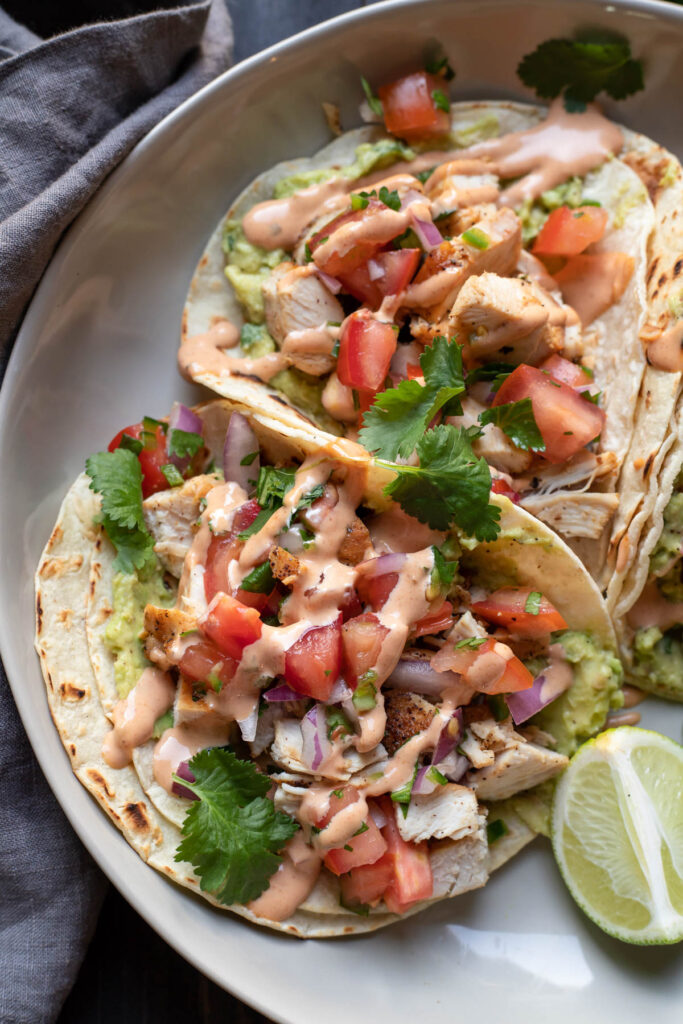 chicken street tacos on a plate.