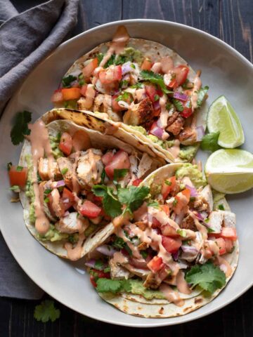 chicken street tacos on a plate.