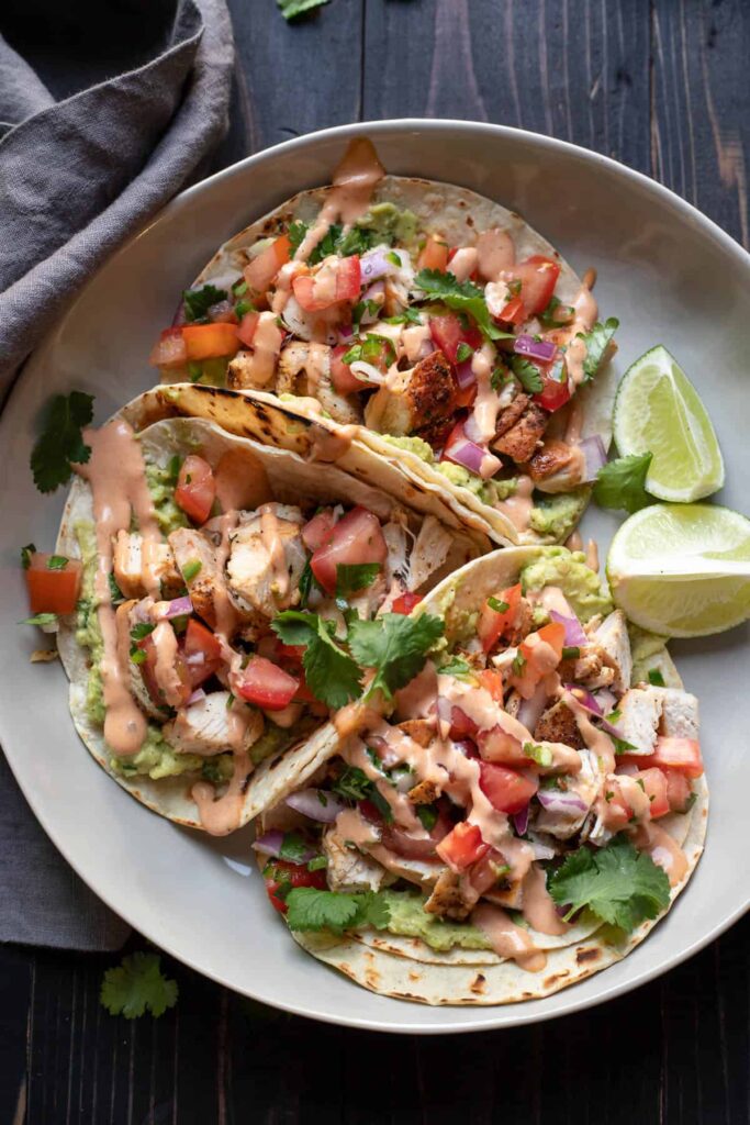 chicken street tacos on a plate.