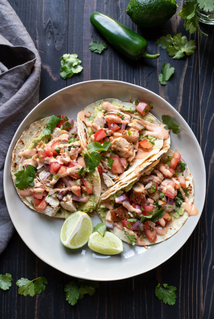 chicken street tacos on a plate.