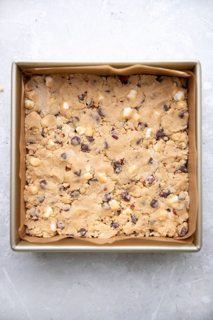 brownie pan full of uncooked rocky road cookie dough
